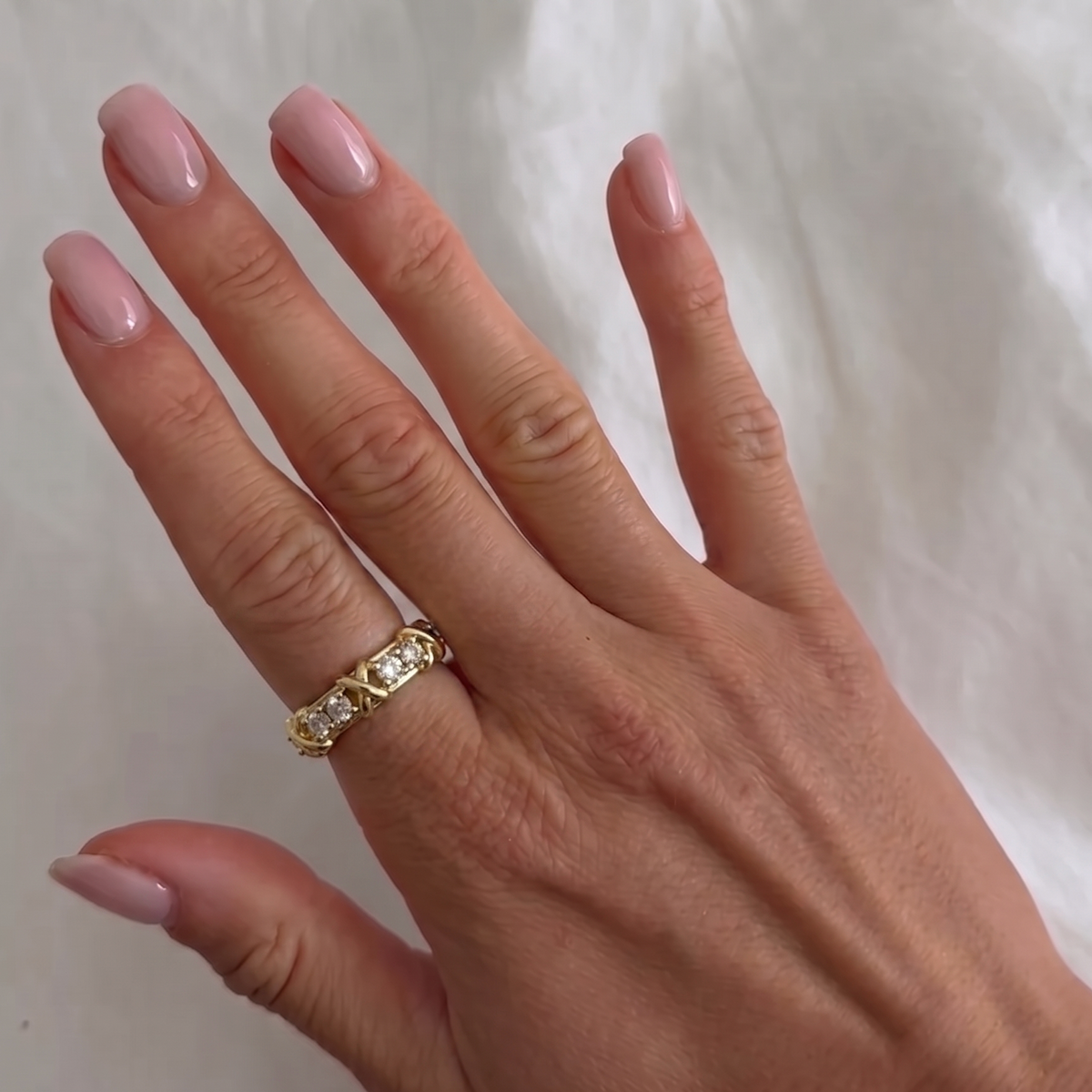 Silver XOXO ring from İrva Collection with intricate design and polished finish, stylish jewelry accessory.