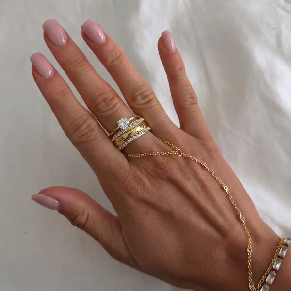 Gold Queen Ring from İrva Collection featuring intricate design and elegant craftsmanship, displayed on a neutral background.