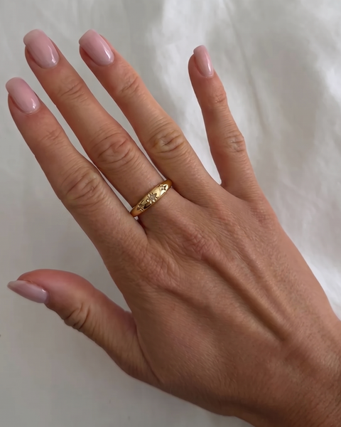 İnce Tılsım yüzük by İrva Collection featuring a delicate gold band with a small engraved talisman pendant.