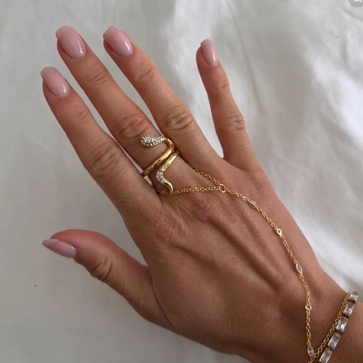 Silver snake ring with gemstone accents from İrva Collection, featuring intricate detailing and a sleek, modern design.