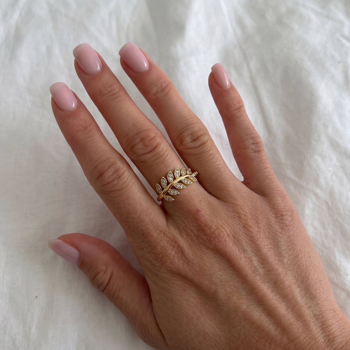 Silver leaf ring with embedded stones from İrva Collection, showcasing intricate design and sparkling details.
