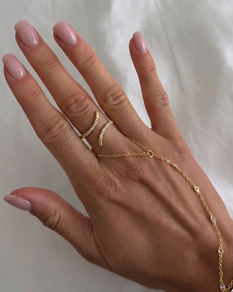 Gold spiral ring with embedded stones from İrva Collection featuring intricate design and sparkling accents.
