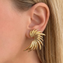 İrva Collection angel wing earrings featuring delicate silver design, perfect for a subtle and elegant jewelry accent.