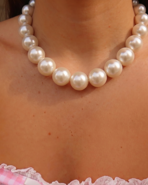Long pearl necklace by İrva Collection featuring large white pearls on a delicate chain, elegant jewelry accessory.