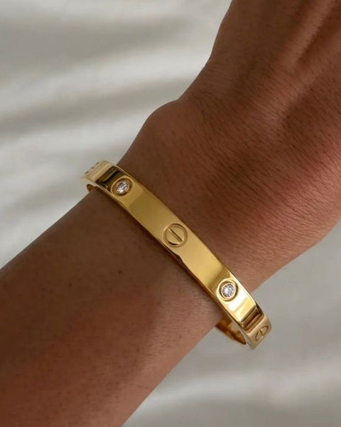 İrva Collection CRT Love Bileklik featuring a delicate bracelet with love-themed charms on a neutral background.