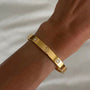 İrva Collection CRT Love Bileklik featuring a delicate bracelet with love-themed charms on a neutral background.
