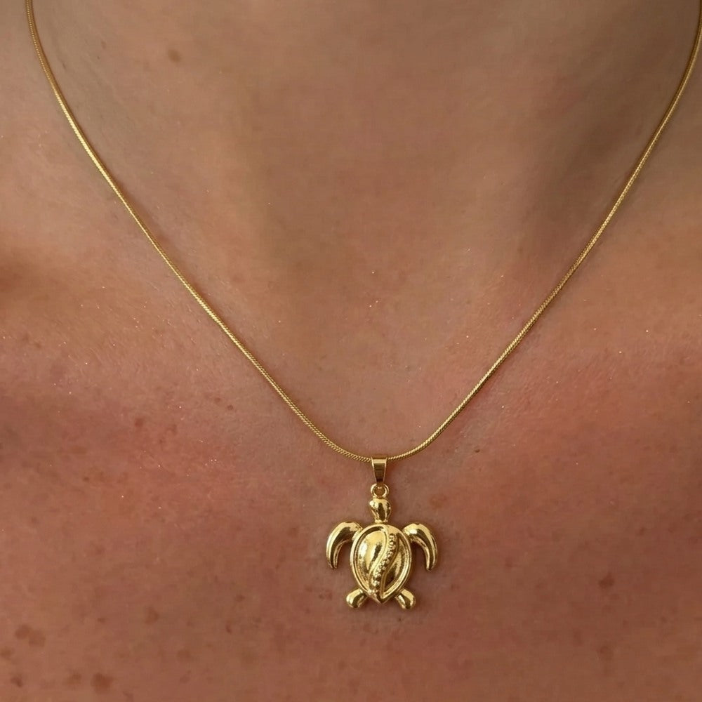 Large turtle pendant necklace from İrva Collection, featuring a detailed turtle charm on a chain.