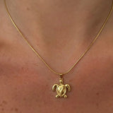 Large turtle pendant necklace from İrva Collection, featuring a detailed turtle charm on a chain.
