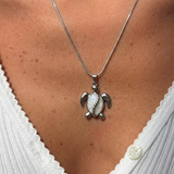 Gold and turquoise beaded turtle pendant necklace from İrva Collection featuring a detailed turtle charm on a delicate chain.