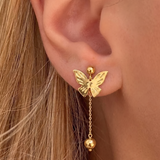 İrva Collection sallantılı kelebek küpe with dangling butterfly design, gold-tone metal, and intricate detailing.