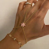 Pembe Çiçek Şahmeran from İrva Collection featuring intricate design with pink flower motifs on a traditional metal piece