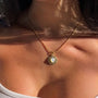 Kararmaz Kedi Göz Kolye by İrva Collection featuring a silver chain and a feline-shaped pendant with green cat's eye gemstone details.