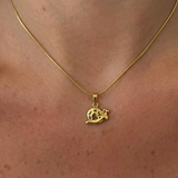 Silver snail pendant necklace from İrva Collection featuring a detailed snail charm on a delicate chain.