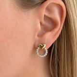 Silver heart-shaped earrings with decorative gemstones from İrva Collection, featuring a stylish and elegant design.