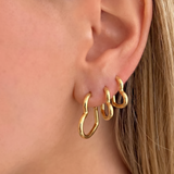 Pair of 3'lü Kalp Küpe earrings from İrva Collection featuring gold-tone heart-shaped dangle jewelry.