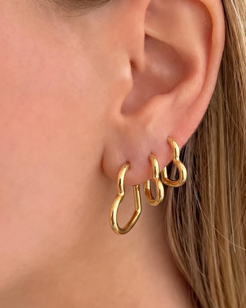 Pair of 3'lü Kalp Küpe earrings from İrva Collection featuring gold-tone heart-shaped dangle jewelry.