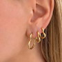 Pair of 3'lü Kalp Küpe earrings from İrva Collection featuring gold-tone heart-shaped dangle jewelry.