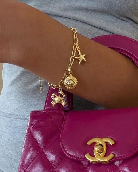 İrva Collection Deniz figürlü charm bileklik with silver-tone chain and Gemini charm, stylish jewelry accessory.