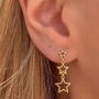 İrva Collection Sallantılı Yıldız Küpe with dangling star design, shiny gold finish, stylish jewelry for women.