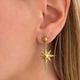 Sallantılı Kutup Yıldızı küpe by İrva Collection featuring a sparkling star design with dangling chain detail