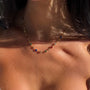 Colorful gemstone necklace from İrva Collection featuring vibrant stones and intricate design, displayed on a neutral background.