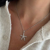 Gold Deniz Yıldızı kolye by İrva Collection featuring a starfish pendant on a delicate chain.
