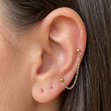 İrva Collection çift delik zincir küpe with dangling Gemini-shaped charms on a white background