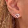 Gold heart-shaped earrings with sparkling stones from İrva Collection, featuring a stylish and elegant design.