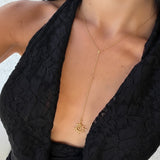 İrva Collection Güneş Y kolye with sun pendant on a chain, close-up view of the jewelry design and craftsmanship.