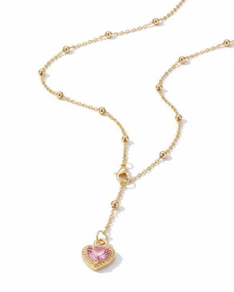 Pink heart-shaped Y necklace from İrva Collection displayed on a white background.